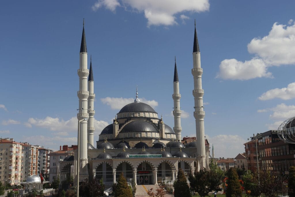 pexels-photo-12840440-12840440 Stunning view of the grand mosque in Konya, Turkey with minarets and clear blue skies.