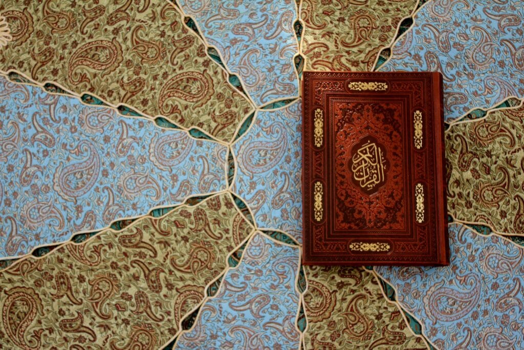 pexels-photo-20623401-20623401 An intricately ornamented Quran resting on a traditional Persian textile pattern in Kashan, Iran.