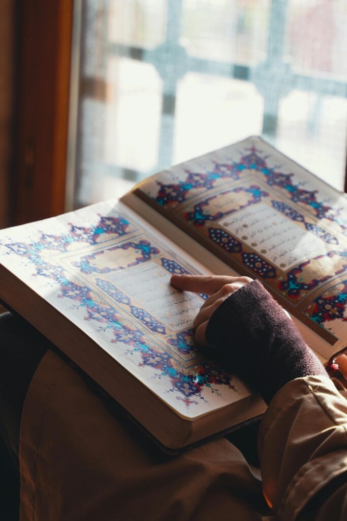 pexels-photo-36280167-36280167 Person engaging with the Quran by a sunlit window in Adana, Türkiye.